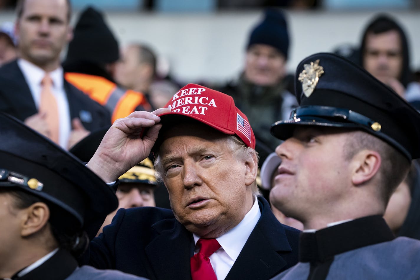 President Donald Trump sits with Army cadets during the Army-Navy football game, at Lincoln Financial Field in Philadelphia, Dec. Dec. 14, 2019. Trump touted a new Department of Defense policy announced last month that allows athletes who play for military academies to seek to delay their service obligations if they pursue professional sports. (Al Drago/The New York Times)