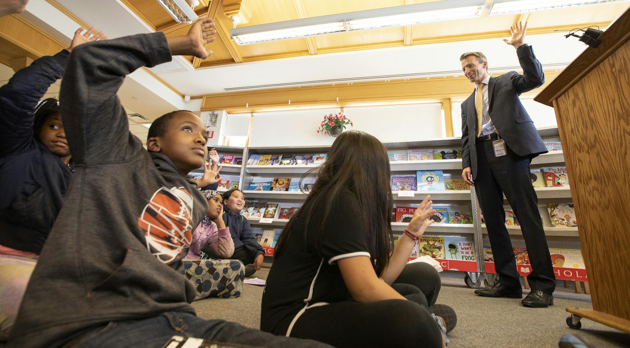 Minneapolis Schools superintendent Ed Graff talks to a group of students about the importance of reading including sixth grader Zack Abdi, left, who is a big fan of the Garfield books. ] LEILA NAVIDI ï leila.navidi@startribune.com BACKGROUND INFORMATION: Minneapolis schools kicks off its summer reading campaign with a free book fair hosted by Start Reading Now for students at Hmong International Academy in Minneapolis on Tuesday, May 22, 2018.