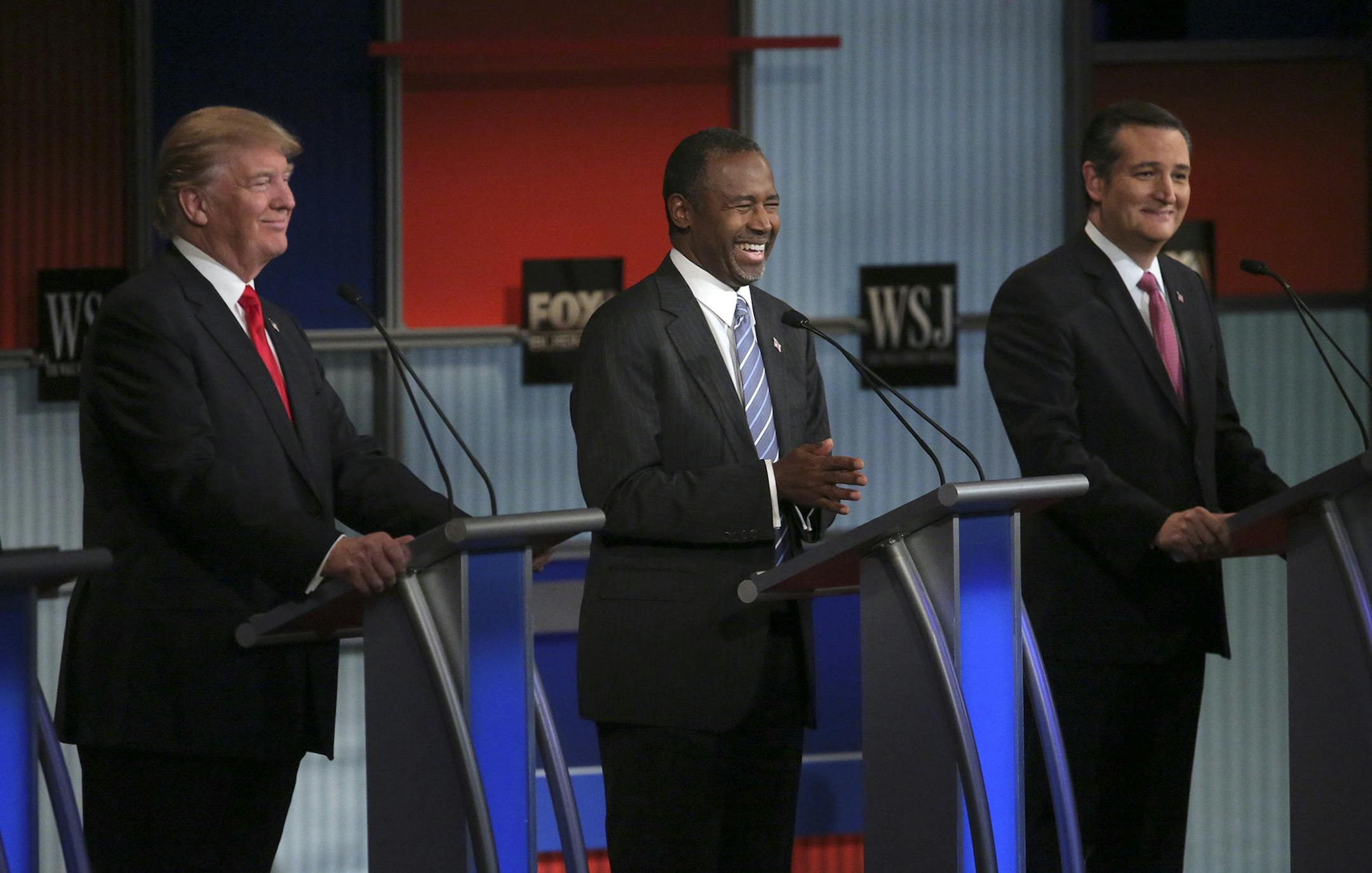 Ben Carson laughs during the Republican debate at the Milwaukee Theatre in Milwaukee, Nov. 10, 2015. From left: Donald Trump, Carson and Sen. Ted Cruz (R-Texas). (Michael Appleton/The New York Times) ORG XMIT: MIN2015120812421558