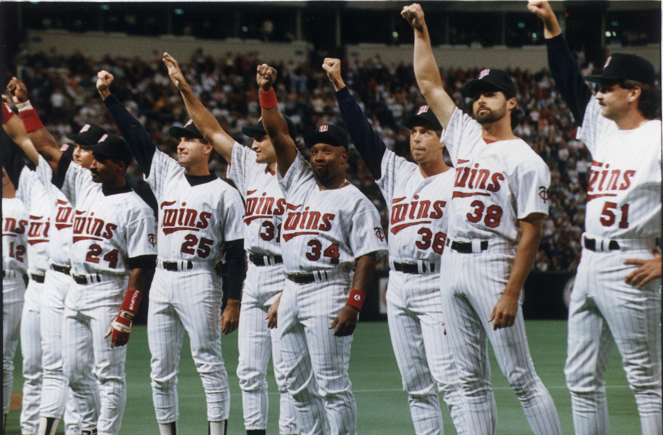 Several Twins baseball players, including Shane Mack (24), Randy Bush (25), Scott Leius (31), Kirby Puckett (34), Kevin Tapani (36), Rick Aguilera (38), and Carl Willis (51) showed their World Series rings