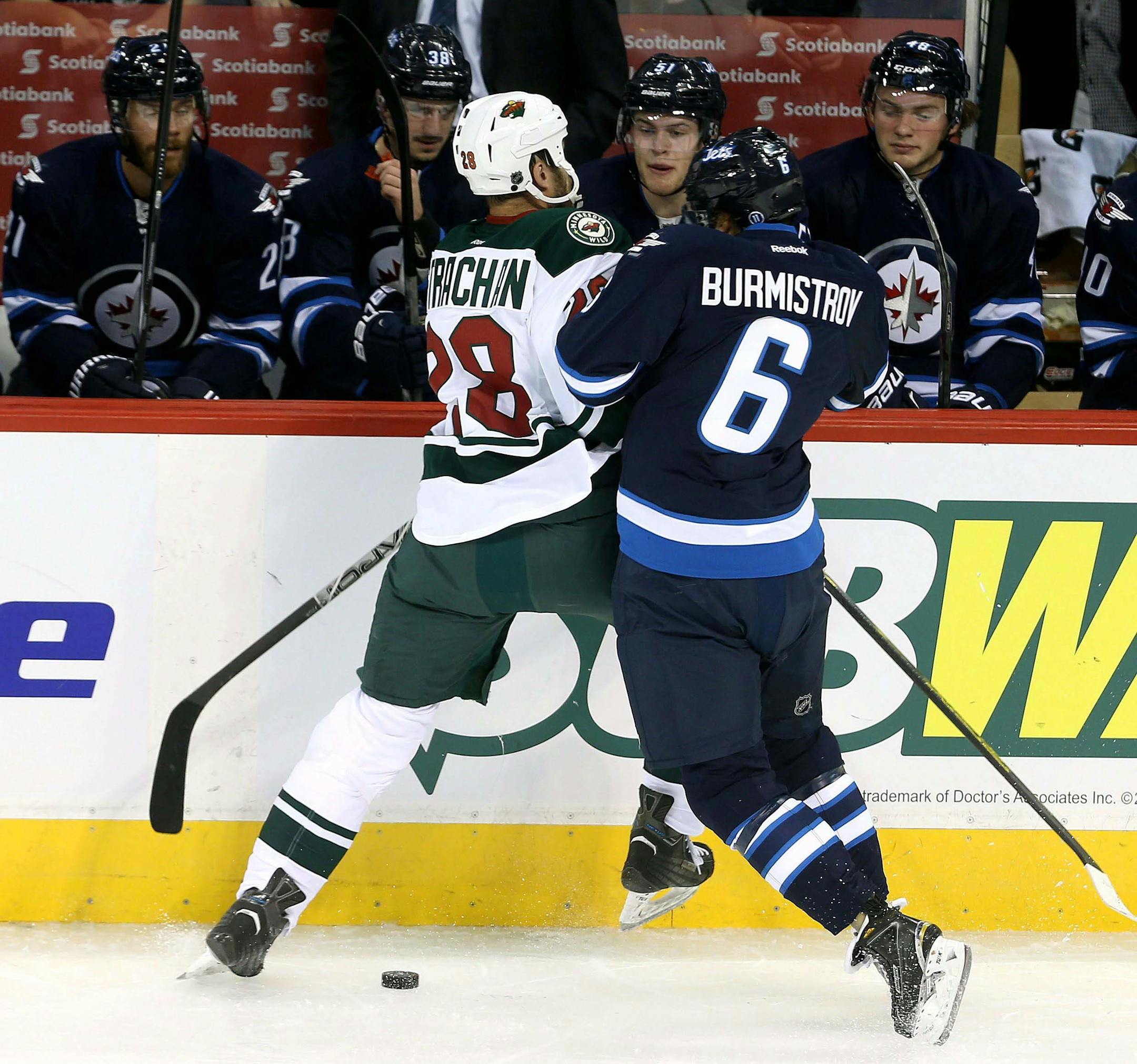 Minnesota Wild's Tyson Strachan, left, collides with Winnipeg Jets' Alexander Burmistrov during the first period of an NHL preseason hockey game Tuesday, Sept. 22, 2015, in Winnipeg, Manitoba. (Trevor Hagan/The Canadian Press via AP) MANDATORY CREDIT