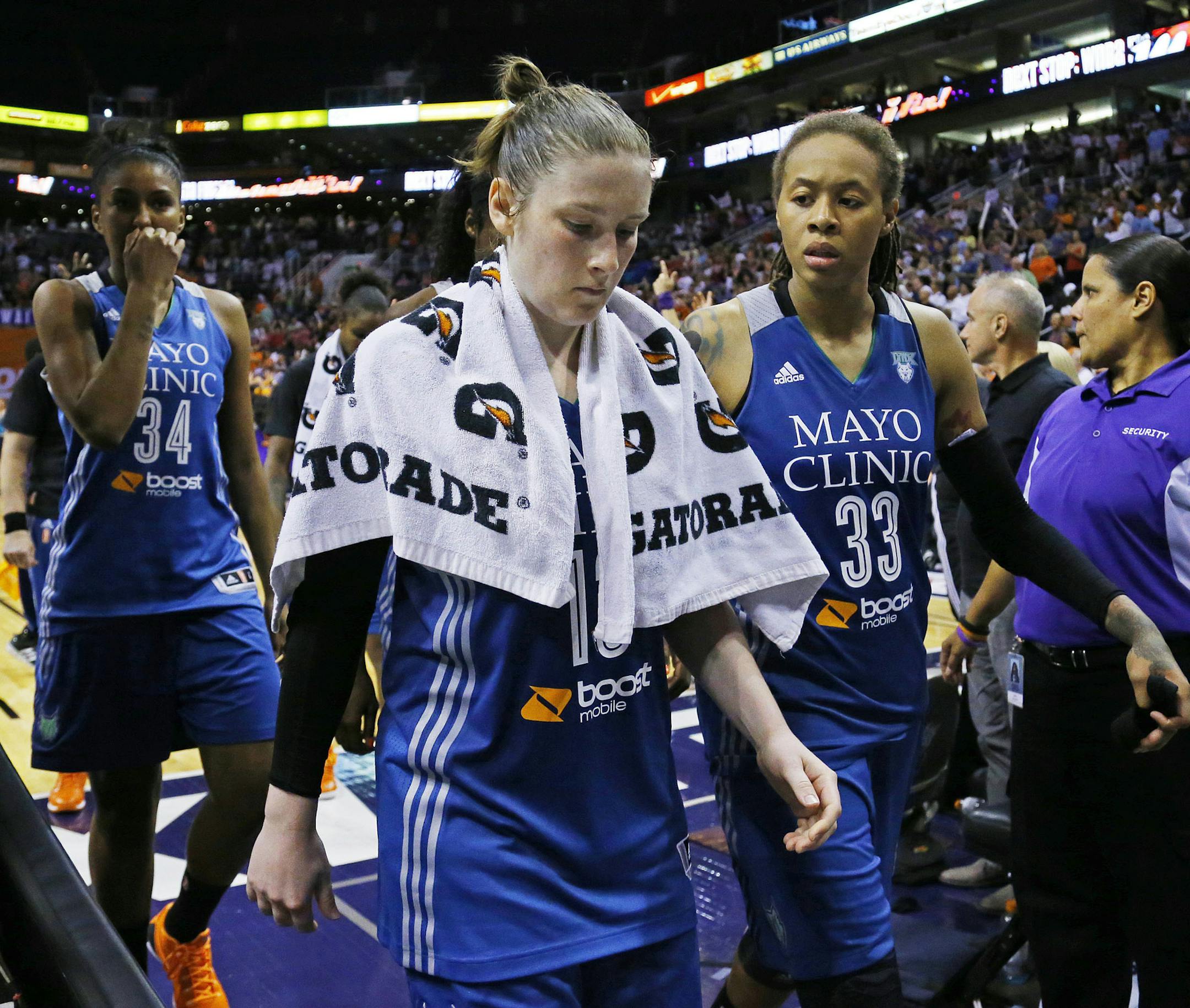 Minnesota Lynx forward Damiris Dantas (34) Lindsay Whalen and Seimone Augustus leave the court after their loss to the Phoenix Mercury celebrate their 96-78 win over the Minnesota Lynx in game 3 of the WNBA Western Conference finals Tuesday, Sept. 2, 2014 in Phoenix Ariz.