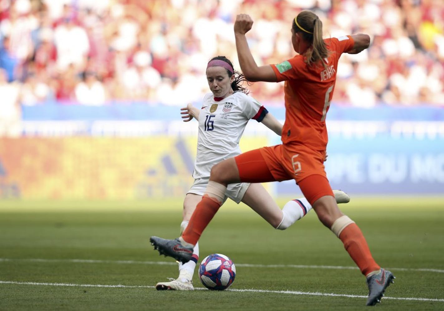 Rose Lavelle, left, scores her side's second goal during the Women's World Cup final.