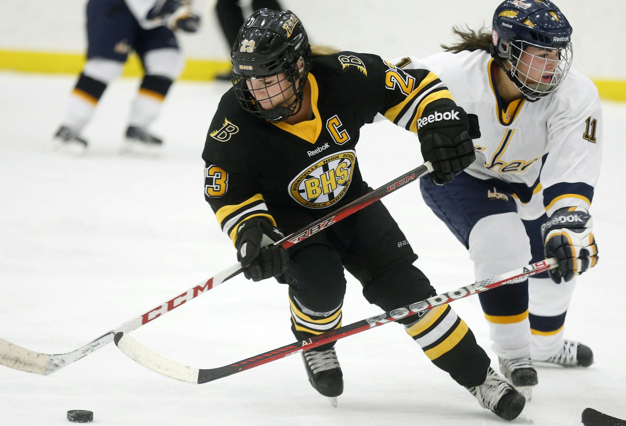 In a game between Prior Lake and Burnsville girls' hockey team at the Dakotah ice arena in Prior Lake, Paige Skaja(23) got past Bailey Halstrom(11) of Prior Lake
