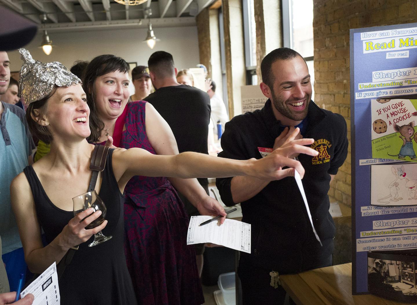 Katie Josephs left and Tiana Malone listened as Brian Sweis a University of Minnesota neuroscience medical student discussed his science fair project Sunday, April 17th, 2016 at Sisyphus Brewing in Minneapolis, MN.] The Grown Up Club, a group of adults that enjoy after-school type activities held a Science Fair (for grown ups at Sisyphus Brewing). Jerry Holt /Jerry.Holt@Startribune.com