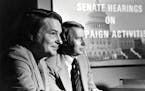 This 1973 image released by PBS shows co-anchors Jim Lehrer, left, and Robert MacNeil reporting on the Watergate hearings. PBS announced that Lehrer d
