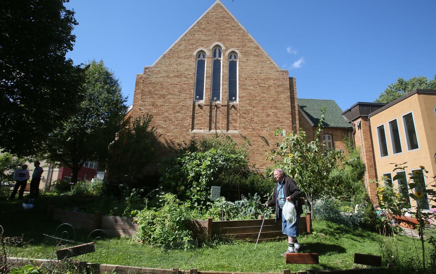 Church member Arlin Carlson with a bag of green beans he harvested from the church garden at Northeast United Methodist Church in Minneapolis.