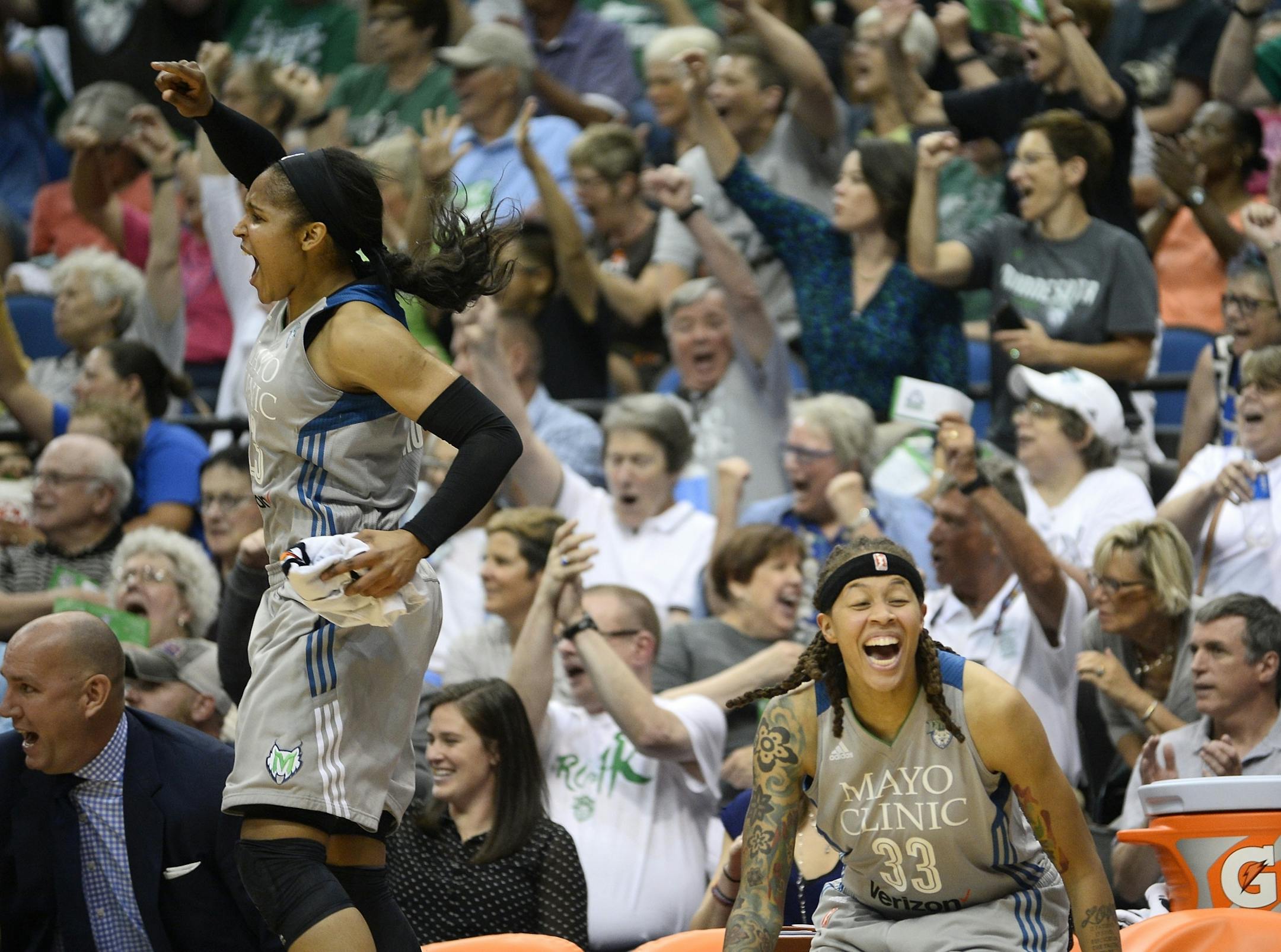 Minnesota Lynx forward Maya Moore (23) and guard Seimone Augustus (33) celebrated a steal and a shot attempt in the final seconds of the first quarter Friday night against the Seattle Storm.