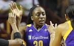 Los Angeles Sparks forward Nneka Ogwumike (30) high fives teammates guard Odyssey Sims, left, and center Candace Parker, right, in the first half of G