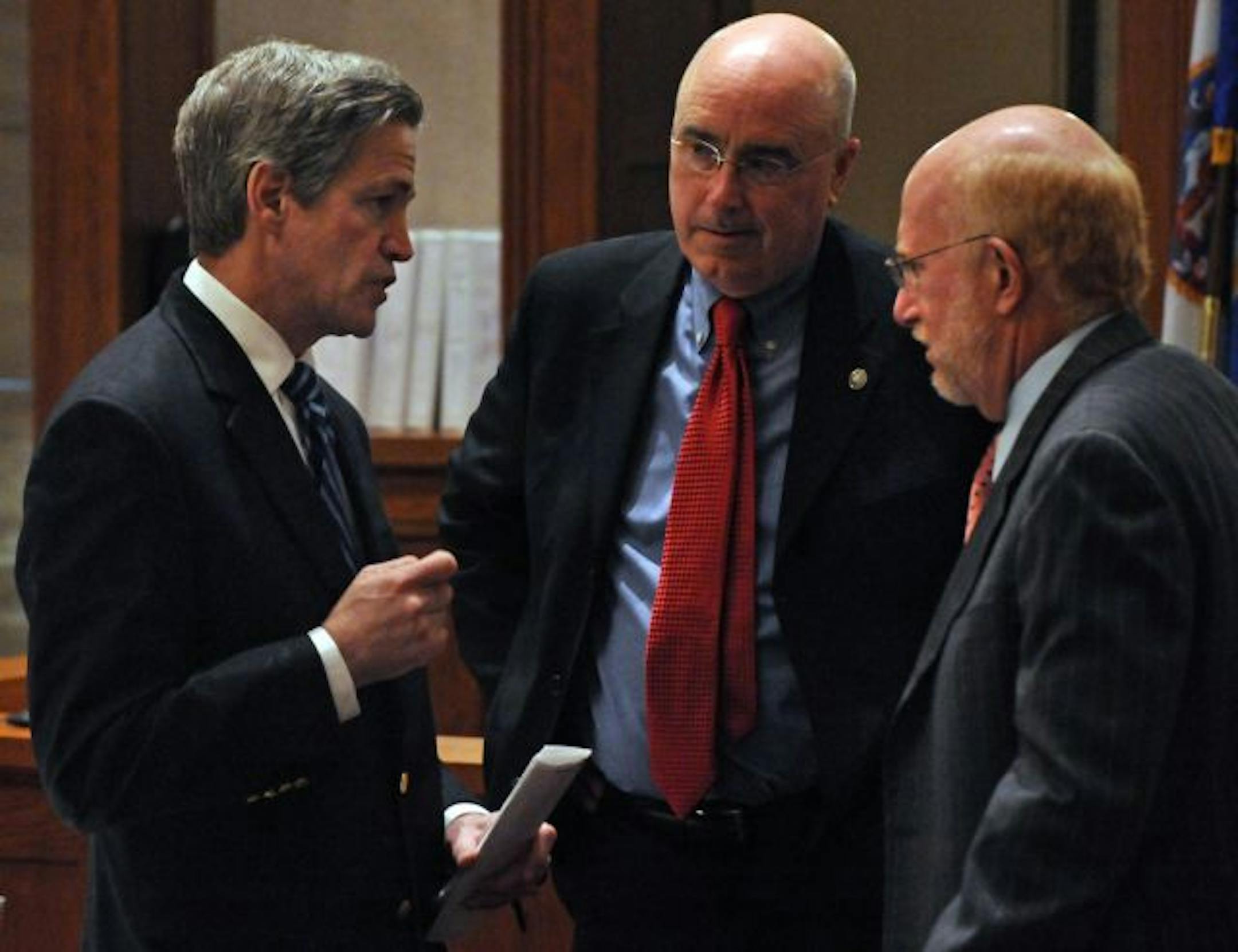 Norm Coleman and his attorneys Fritz Knaak, center, and Ben Ginsberg talked strategy during a break in the action Tuesday.