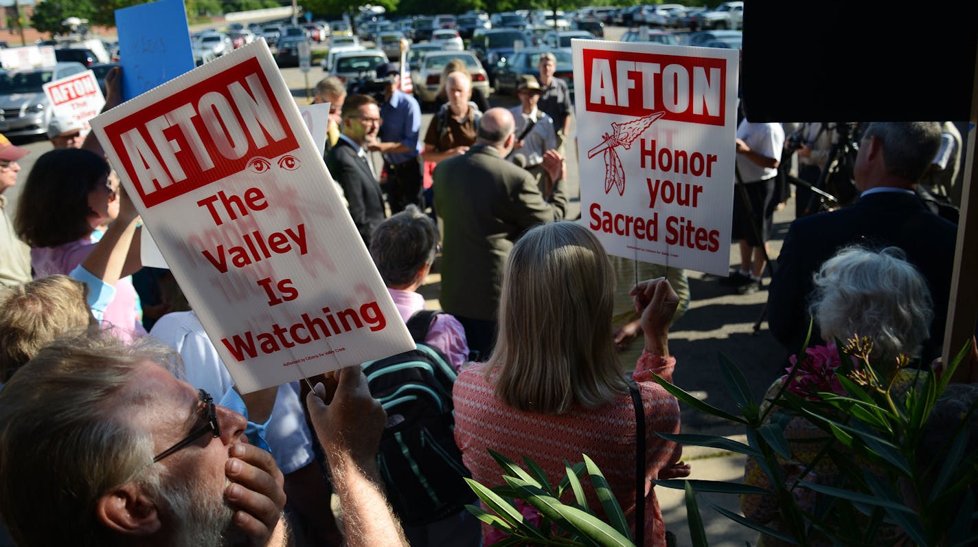 People hold signs during the press conference held outside of the Pollution Control Agency that fought against the Minnesota Pollution Control Agency Citizens' Board concluding. The press conference and final meeting was held in St. Paul, Minn., on Tuesday June 23, 2015. ] RACHEL WOOLF &#x2211; rachel.woolf@startribune.com