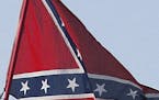 FILE - In this March 18, 2005, file photo, Confederate stars and bars flags fly on = poles attached to campers at Atlanta Motor Speedway in Hampton, G