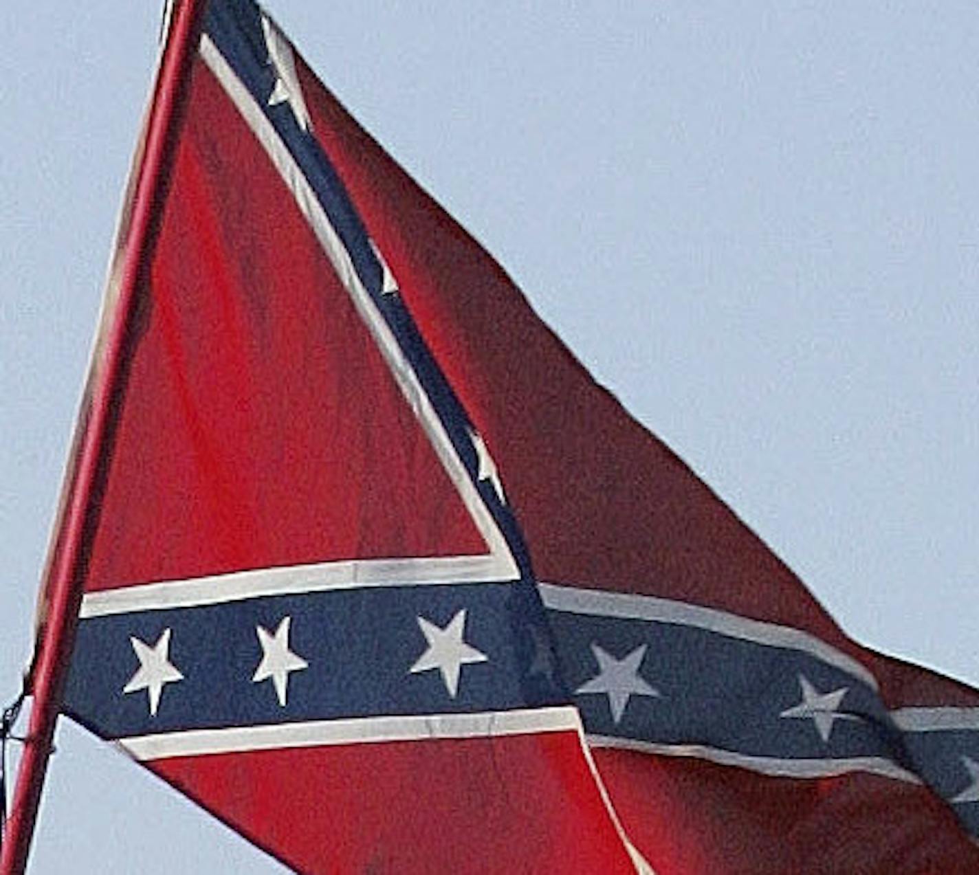 FILE - In this March 18, 2005, file photo, Confederate stars and bars flags fly on = poles attached to campers at Atlanta Motor Speedway in Hampton, Ga. NASCAR has a checkered racial history, from a long-time affinity for Confederate flags among the fan base to a driver losing his job just this season for casually uttering a racial epitaph.(AP Photo/Ric Feld, File)