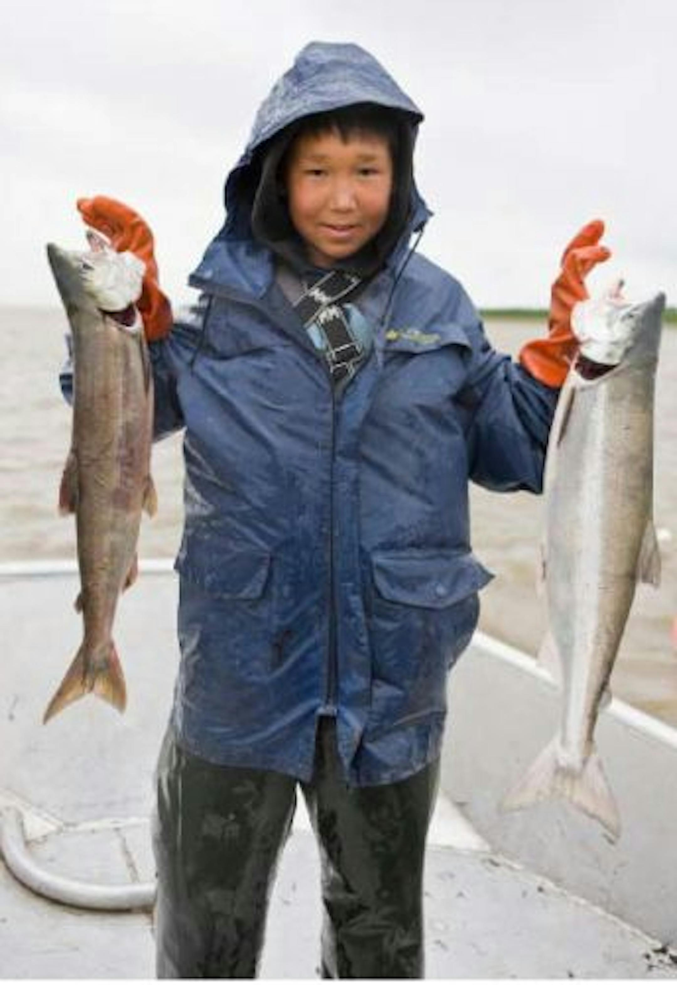 Alaskan child with chum salmon from the book "Fish Tales" by Bart van Olphen and Tom Kime.