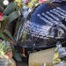 Messages on a helmet is placed at a memorial rally and car cruise in Valencia, Calif., Sunday, Dec. 8, 2013 to remember actor Paul Walker and his frie