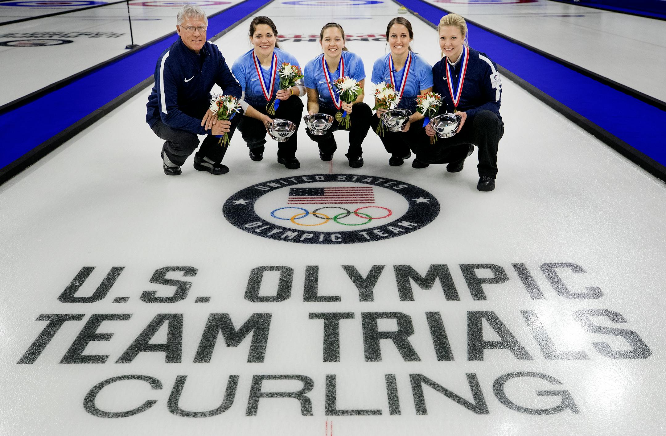 Team Roth coach Al Hackner, Becca Hamilton (McFarland, Wis.), Aileen Geving (Duluth, Minn.), Tabitha Peterson (Eagan, Minn.), and team skip Nina Roth (McFarland, Wis.). Team Roth beat Team Sinclair to represent the USA in the 2018 Winter Olympics.