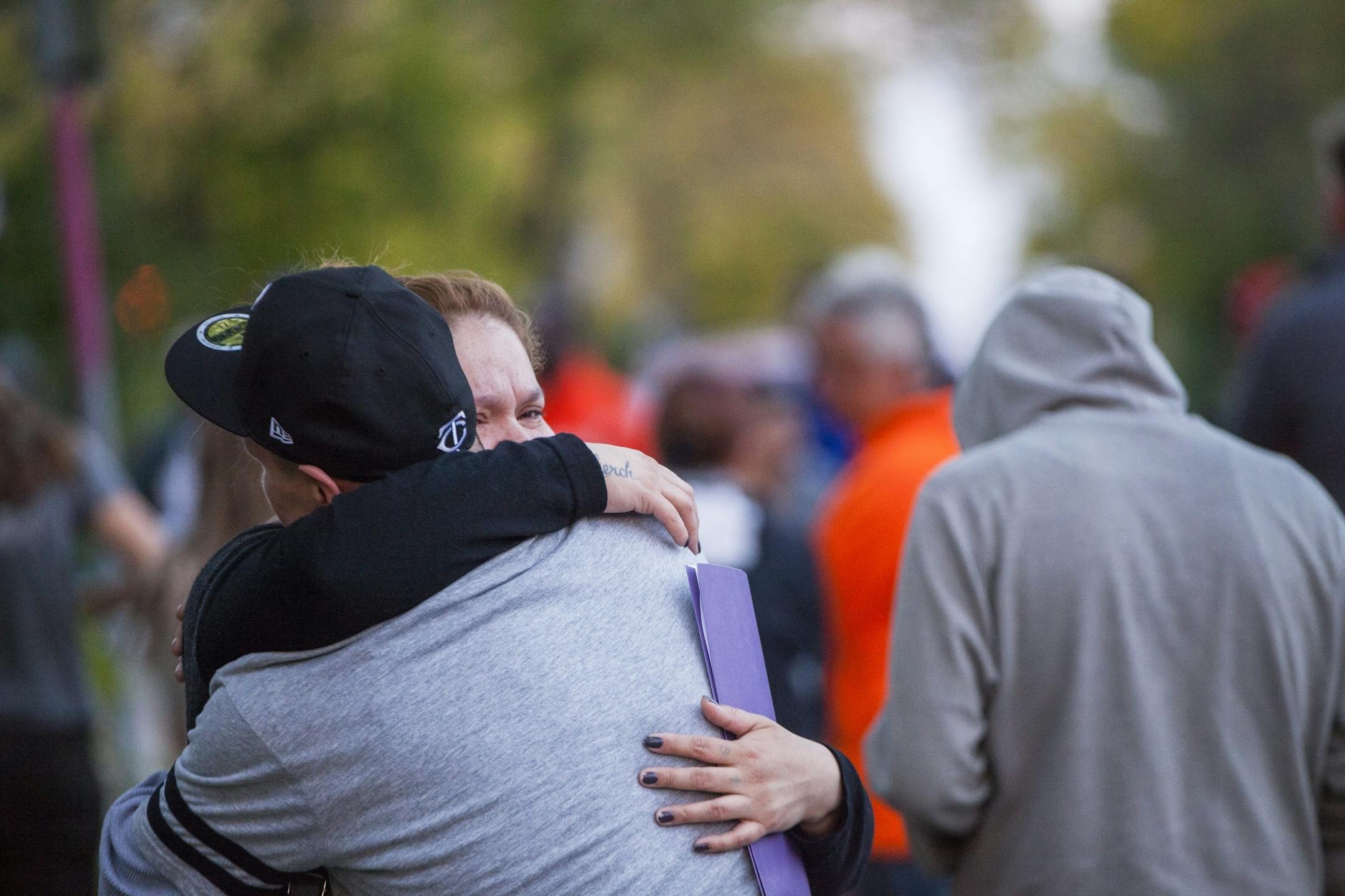 Julia Johnson and Gomer Thompson comforted each other as community members gathered in a support circle. Gustav Christianson was their younger sibling.