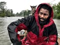 Robert Simmons Jr. and his kitten "Survivor" are rescued from floodwaters after Hurricane Florence dumped several inches of rain in the area overnight