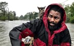 Robert Simmons Jr. and his kitten "Survivor" are rescued from floodwaters after Hurricane Florence dumped several inches of rain in the area overnight