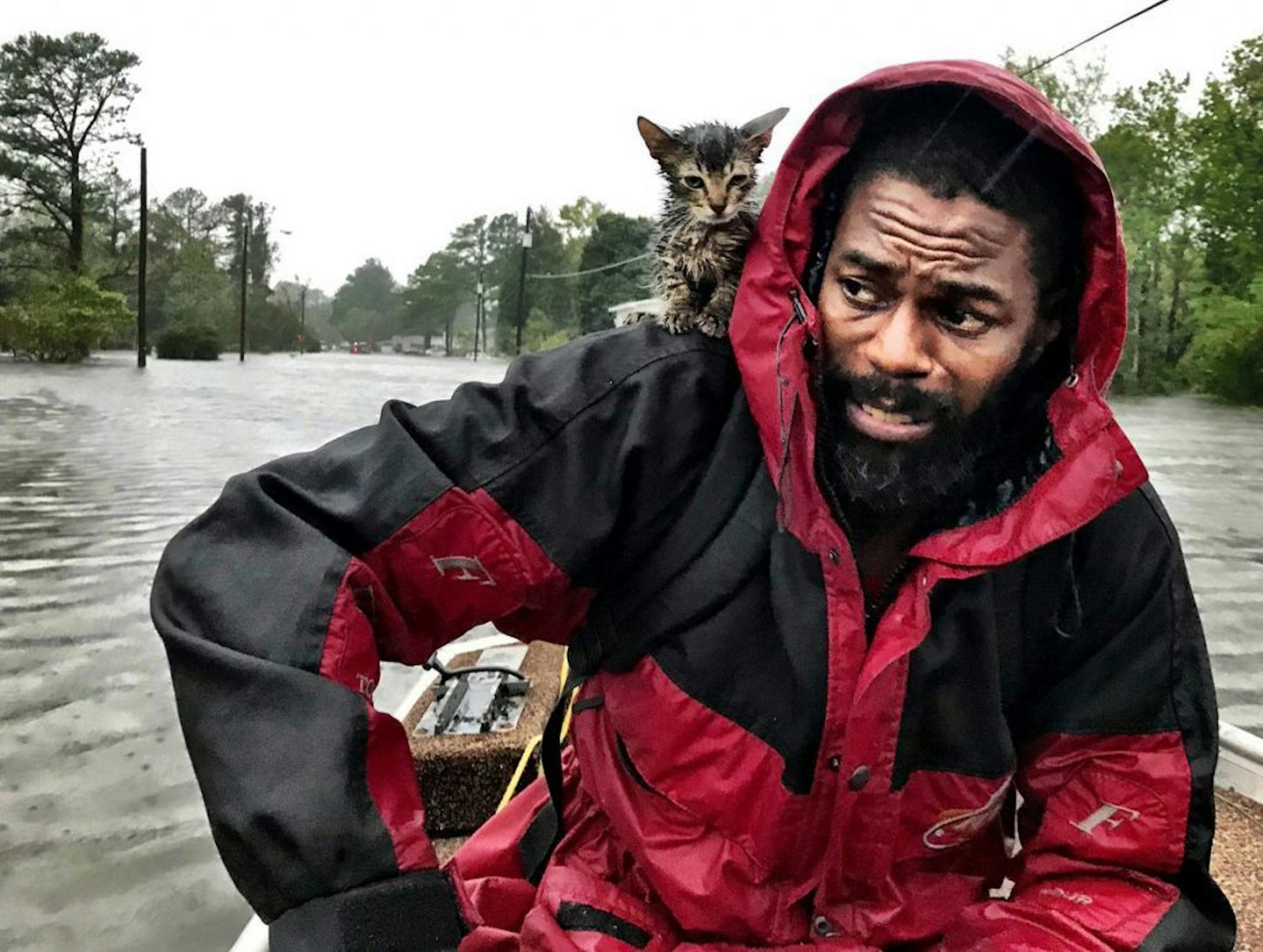 Robert Simmons Jr. and his kitten "Survivor" are rescued from floodwaters after Hurricane Florence dumped several inches of rain in the area overnight Friday in New Bern, N.C.
