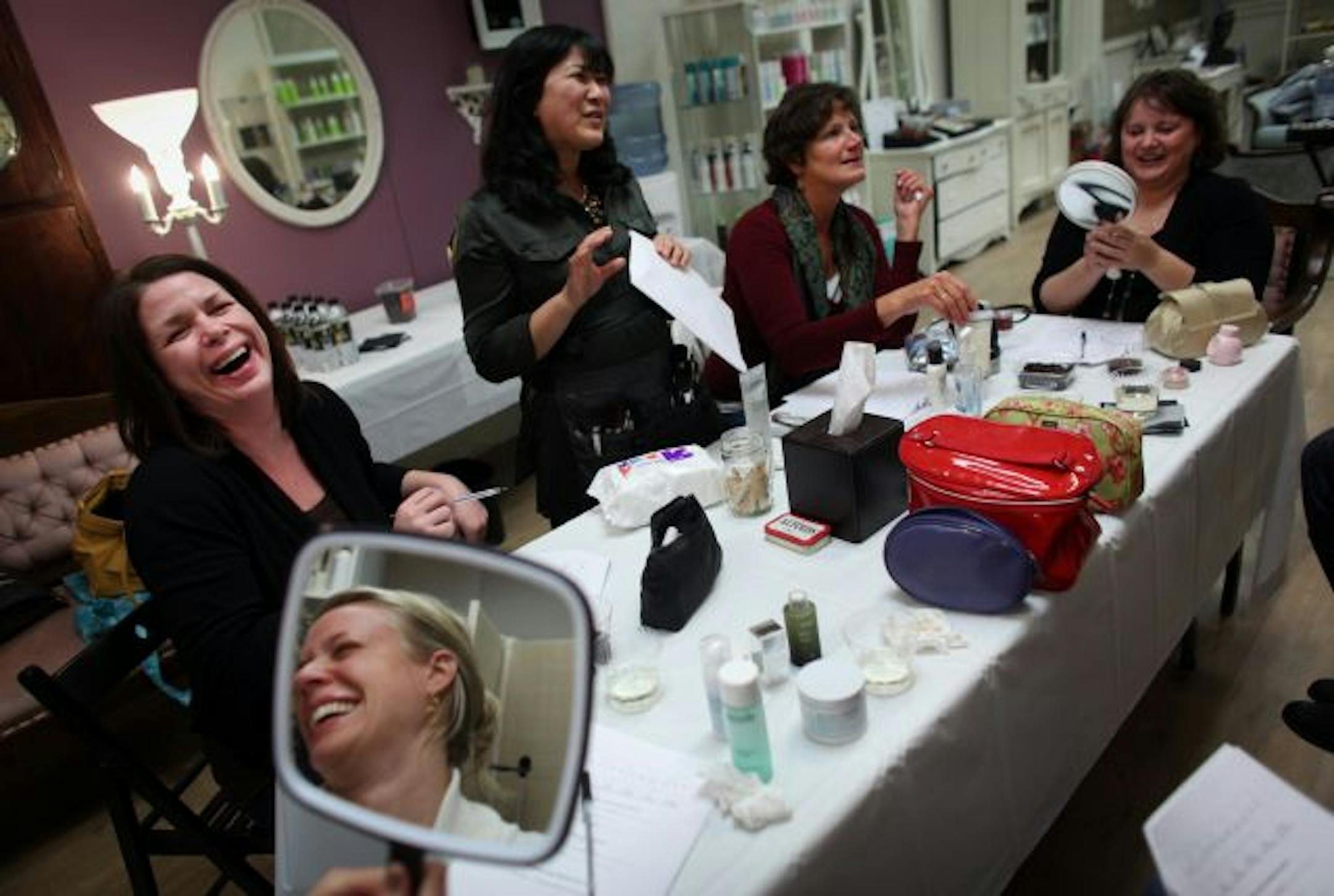 Lynsey Tjaden (in mirror) laughed with Sheri Wallentine during a class at Smart and Chic. Also pictured, from right: Jen Kos, Kathy Davison and Julie Swenson.