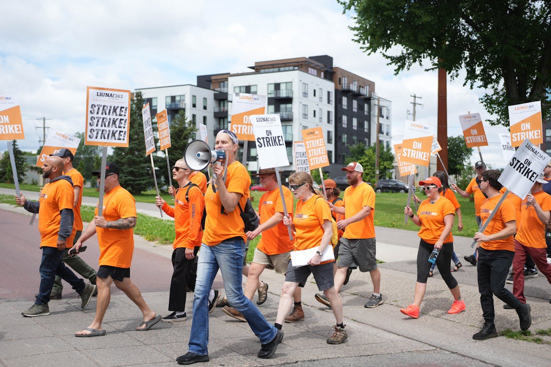Arborist Kerrick Sarbacker leads union chants as striking park workers picket at a busy Minnehaha Park on Friday. Members of Laborers 363, who maintai