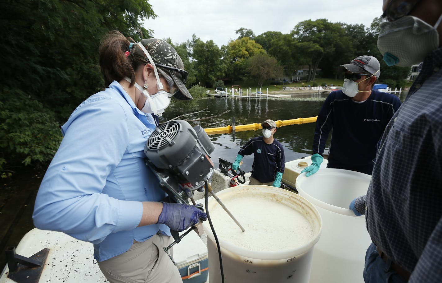 FILE -- Megan Weber, product development manger for Marrone Bio Innovations, mixed a batch of Zequanox to try to control an infestation of zebra mussels on Christmas Lake on Monday September 8 , 2014.