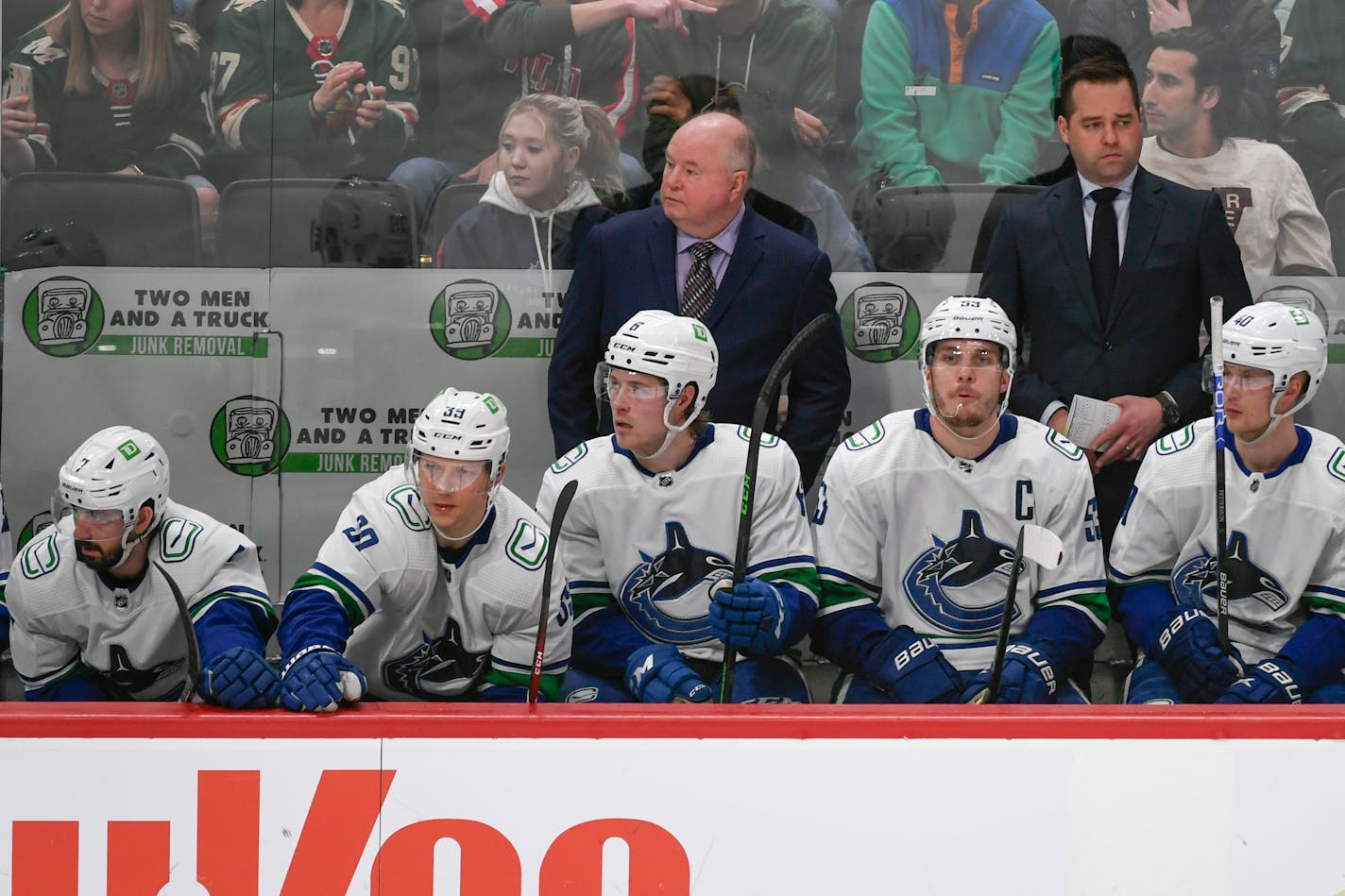 Vancouver Canucks coach Bruce Boudreau, top left, watches the team's NHL hockey game against the Minnesota Wild during the third period Thursday, March 24, 2022, in St. Paul, Minn. The Wild won 3-2 in overtime. (AP Photo/Craig Lassig)