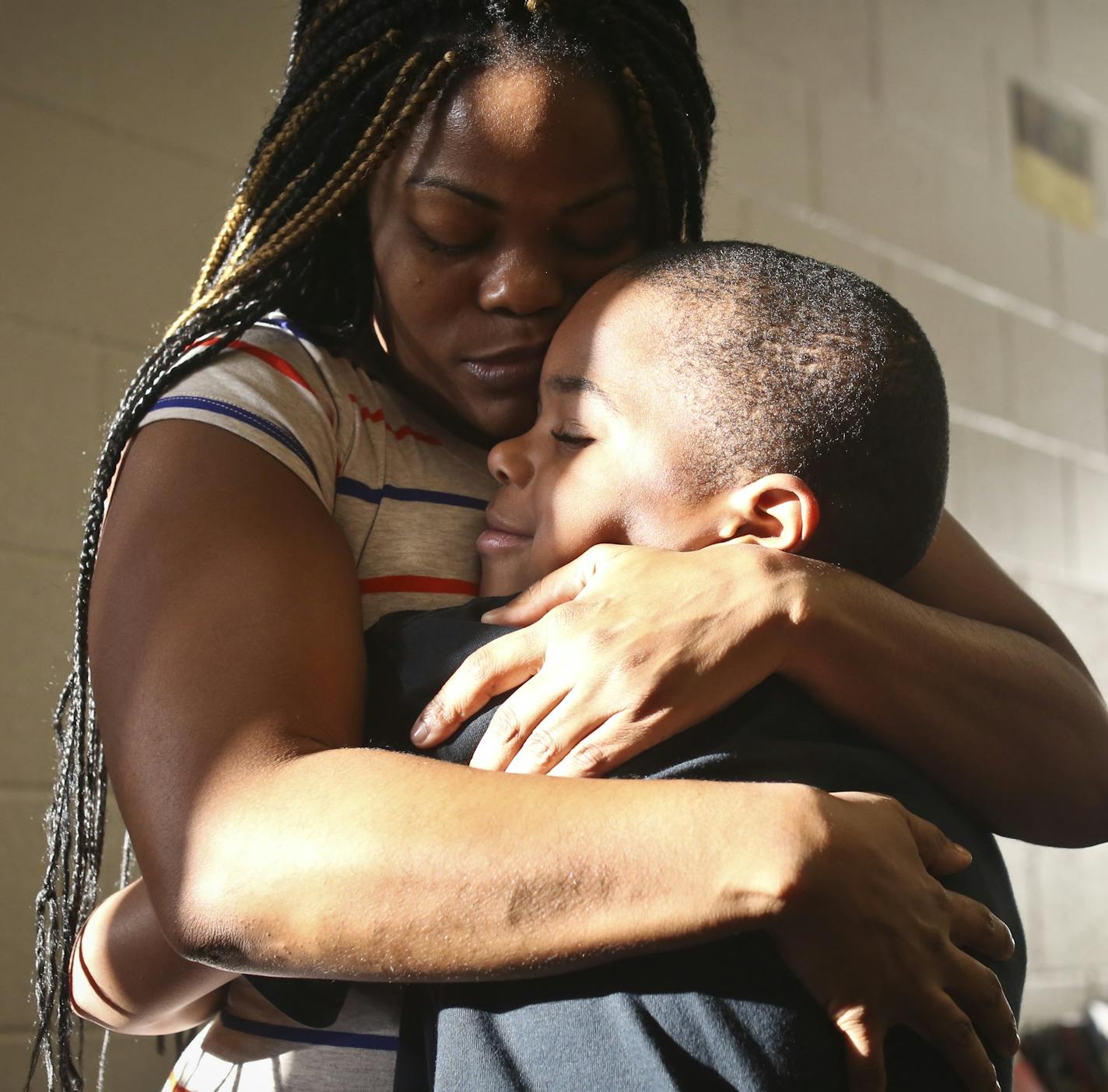 Martiese White hugged his mother Nosha Edwards goodbye at Frost Lake Elementary School on Thursday, November 14, 2013. Frost Lake is one of St. Paul's schools that caused an uproar by moving nearly 300 EBD children our of their self-contained units into mainstream classes when the school year began. Martiese has EBD and was in a special ed program last year where he struggled with behavior problems. His mother says this is a different year because she has not been called once by the school about