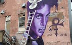 Artist Rock Martinez, 35, Minneapolis, worked on a mural he is painting to honor Prince at 26th Street and Hennepin Avenue.