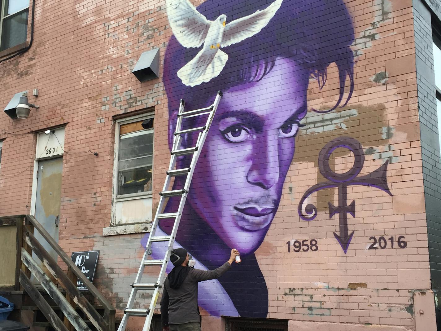 Artist Rock Martinez, 35, Minneapolis, worked on a mural he is painting to honor Prince at 26th Street and Hennepin Avenue.