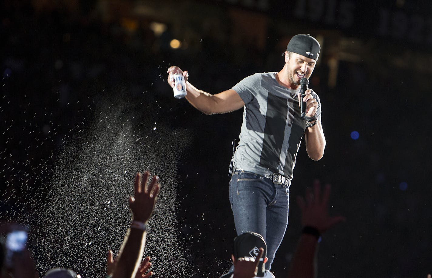 Luke Bryan pours beer on the crowd at his Kick The Dust Up Tour at TCF Bank Stadium in Minneapolis June 20, 2015. (Courtney Perry/Special to the Star Tribune)