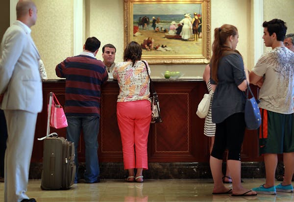 Guests at the check-in counter at the Ritz-Carlton, Key Biscayne on July 27, 2010, in Key Biscayne, Fla. Hotel resort fees have drawn the ire of attor