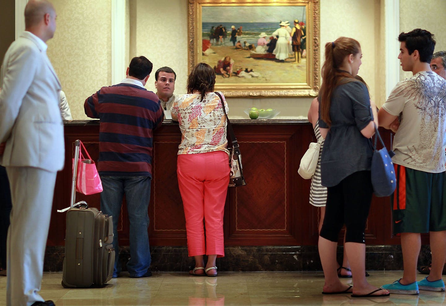 Guests at the check-in counter at the Ritz-Carlton, Key Biscayne on July 27, 2010, in Key Biscayne, Fla. Hotel resort fees have drawn the ire of attorneys general for Nebraska and the District of Columbia as well as travel rights groups because they often aren&#x2019;t disclosed upfront, making travelers think they&#x2019;re getting a better deal than they really are. (Joe Raedle/Getty Images/TNS) **FOR USE WITH THIS STORY ONLY**