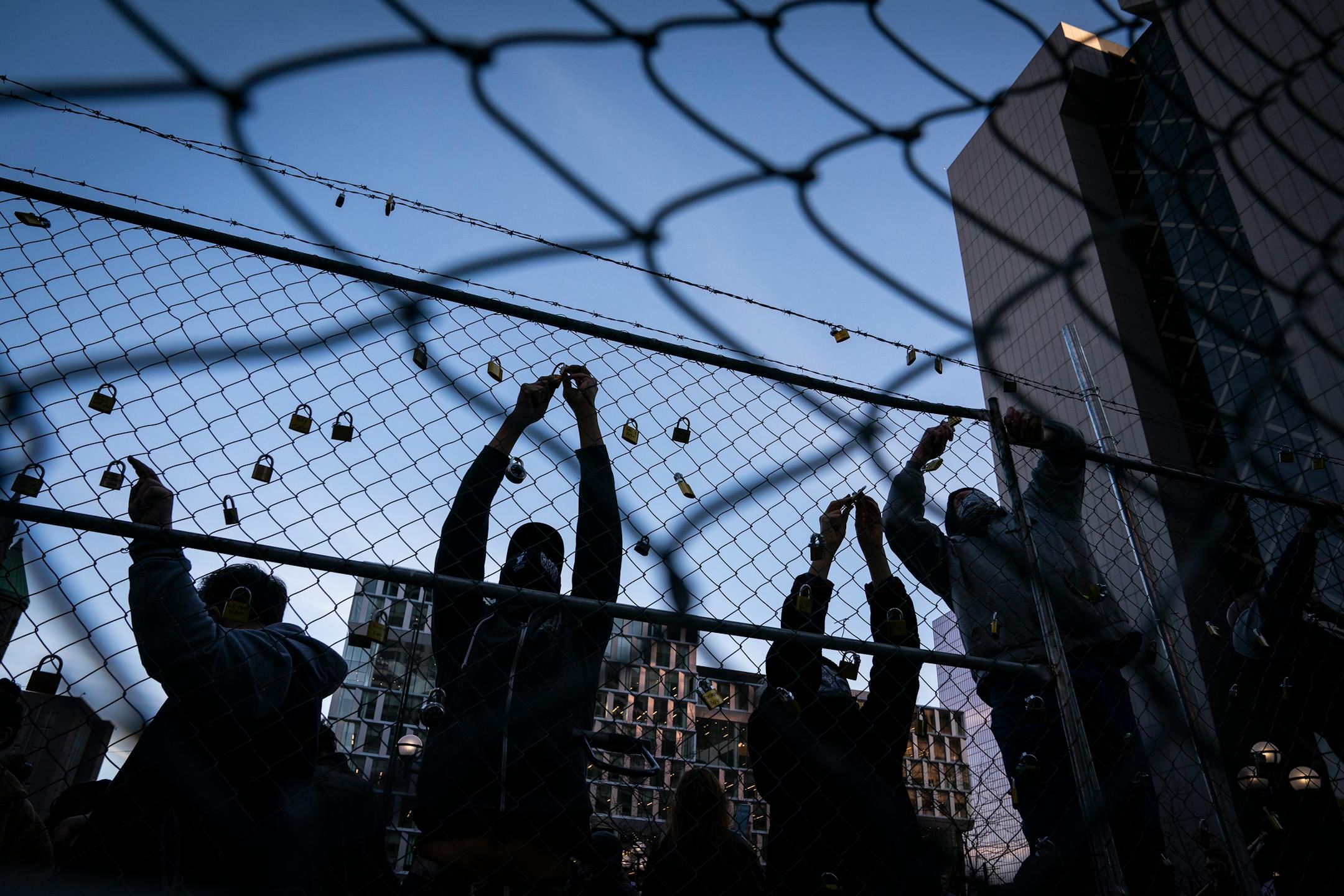 People placed locks with the names of those killed by law enforcement in Minnesota on the fence outside the Hennepin County Government Center during the Locks for Loved Ones Lost: Part II event.