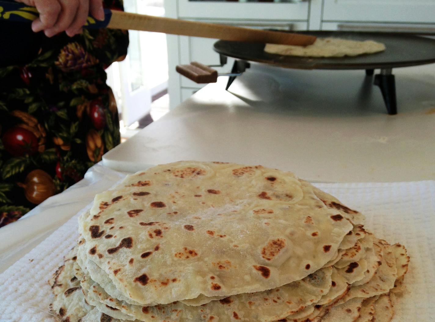 Fresh lefse, grilled one by one and stacked to the side, was made by women at Central Lutheran Church. (Lee Svitak Dean/Star Tribune)