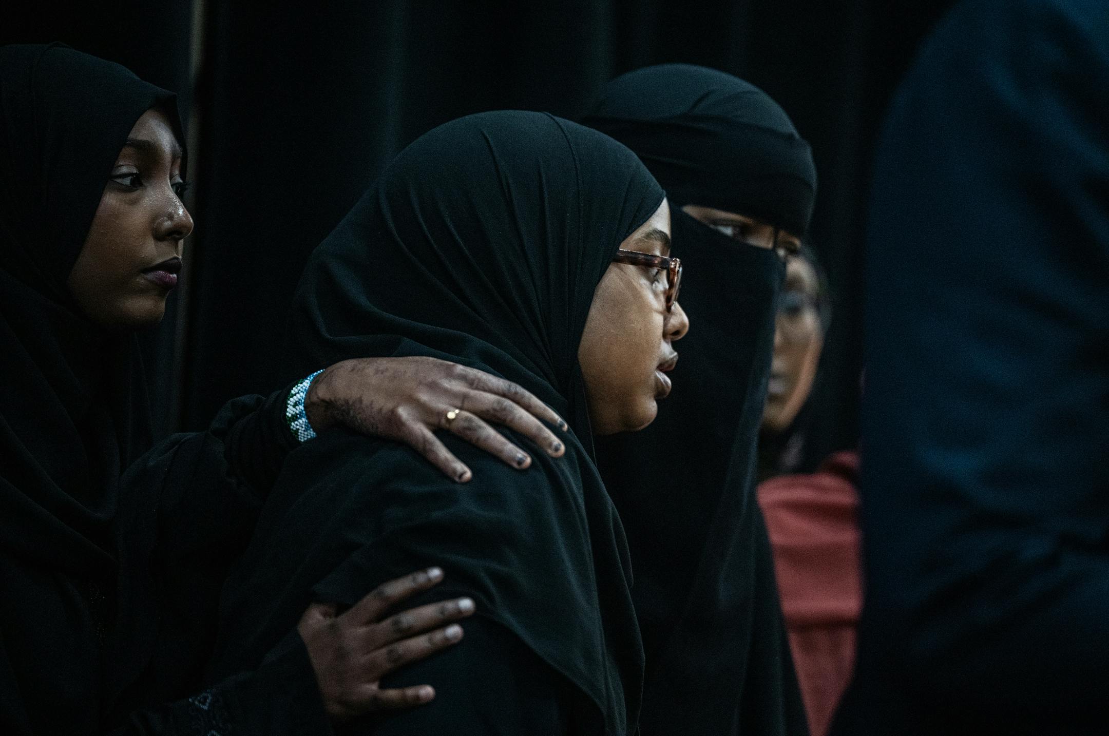 Rukia Gesaade, Yusra Ali and Sundus Mohamoud Ali(L to R) comfort each other a a press conference calling for an independent investigation of a crash that killed five loved ones in Bloomington, Minn., on Monday, June 26, 2023. CAIR-MN is calling for an independent investigation of the crash that killed five in Minneapolis.