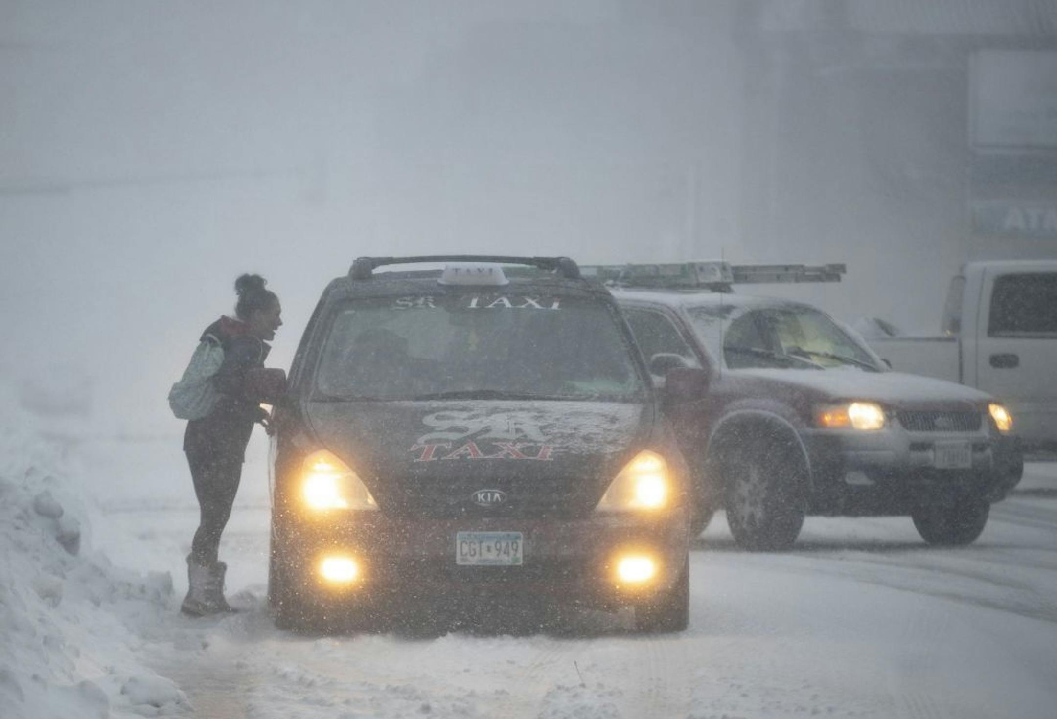 A woman hailed a taxi in Duluth, MN to try and travel during the snow storm on Saturday November 30, 2019.