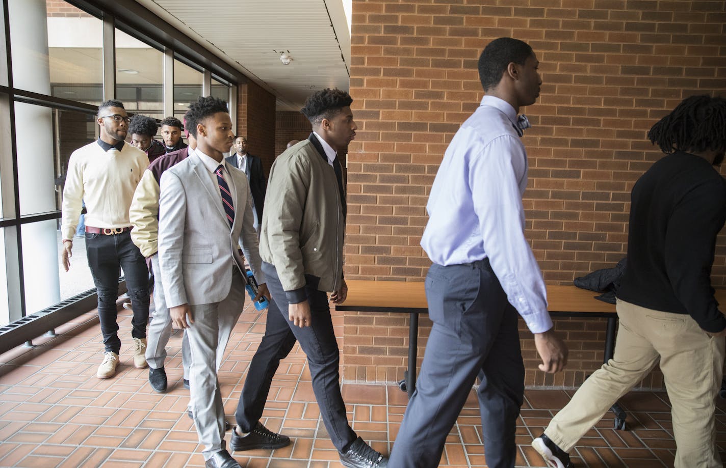 Minnesota Gophers football players walk into their closed door appeal hearing in January.