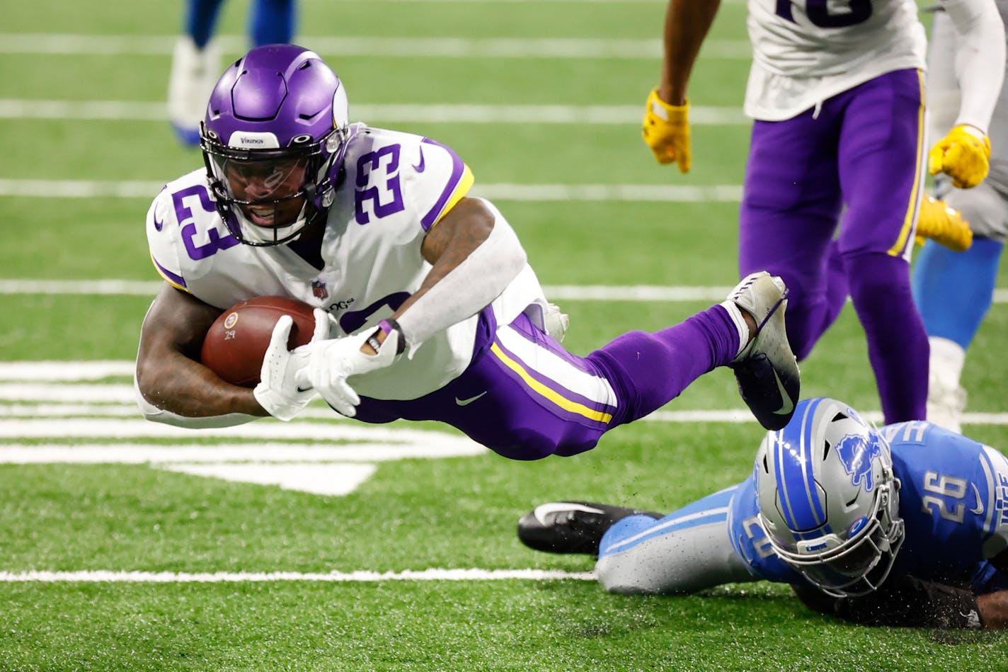 Minnesota Vikings running back Mike Boone (23) dives forecextra yard in the second half against the Detroit Lions during an NFL football game, Saturday, Jan. 3, 2021, in Detroit. (AP Photo/Rick Osentoski)