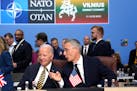 NATO Secretary-General Jens Stoltenberg, right, speaks with President Joe Biden during a meeting of the NATO-Ukraine Council during a NATO summit in V