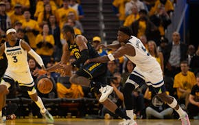 Timberwolves guard Anthony Edwards (5) defends against Golden State Warriors forward Jonathan Kuminga (00) in the second quarter in Game 4 of their NB