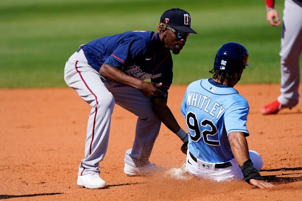 Tampa Bay Rays' Garrett Whitley (92) is tagged out by Minnesota Twins shortstop Nick Gordon (1) as he tries to steal second base in the eighth inning 