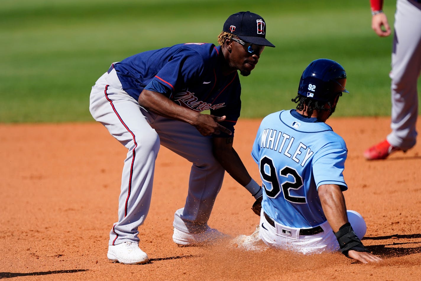 Tampa Bay Rays' Garrett Whitley (92) is tagged out by Minnesota Twins shortstop Nick Gordon (1) as he tries to steal second base in the eighth inning of a spring training baseball game Saturday, March 13, 2021, in Port Charlotte, Fla.. (AP Photo/John Bazemore)