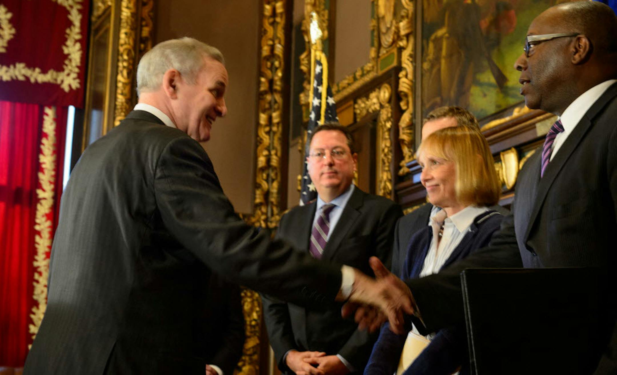 Gov. Mark Dayton shook hands with members of a steering committee organized to convince the NFL to bring the Super Bowl to Minnesota in 2018: (left to right) Vikings V.P. Lester Bagley, Timberwolves' Rob Moor, Michele Kelm-Helgen of the Sports Facilities Authority and Melvin Tennant of Meet Minneapolis.