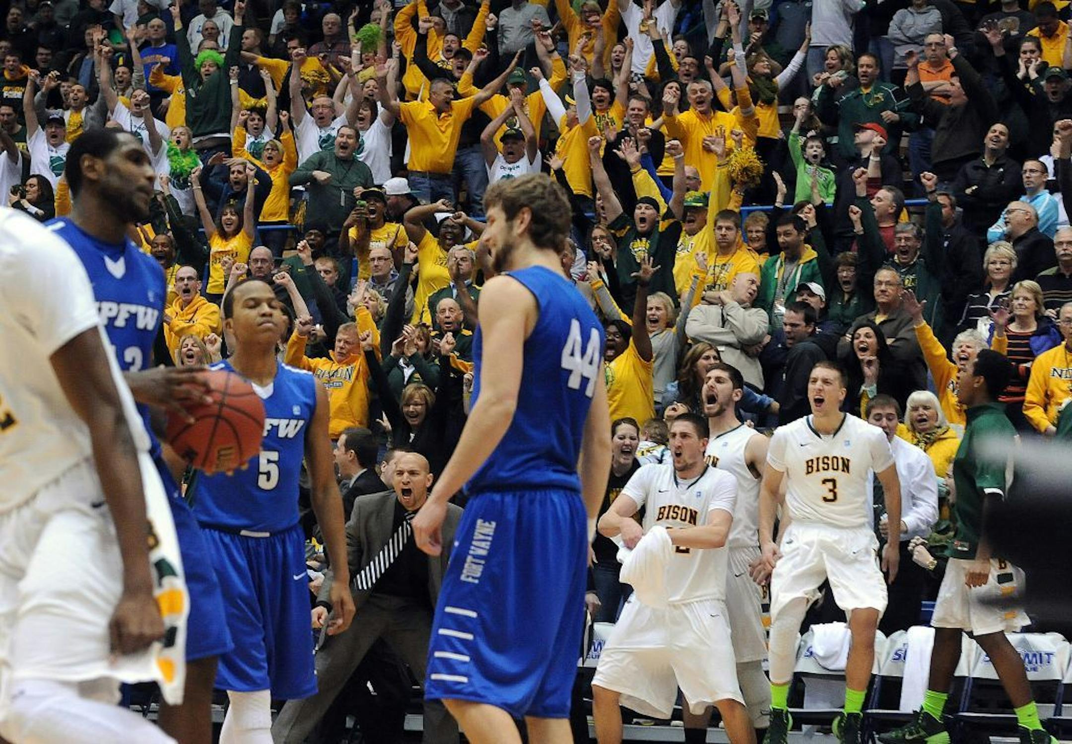 North Dakota State fans cheer after an NDSU score against Indiana-Purdue-Fort Wayne in the closing seconds of an NCAA college basketball game for the Summit League men's tournament title, Tuesday, March 11, 2014, in Sioux Falls, S.D. North Dakota State won 60-57. (AP Photo/Argus Leader, Jay Pickthorn) NO SALES