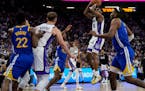 Kings guard De'Aaron Fox (5) shoots during the first half of an NBA play-in tournament game against the Warriors on Tuesday in Sacramento, Calif.