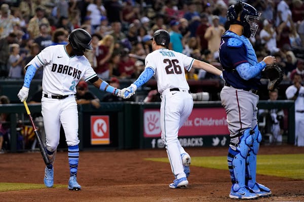 Arizona Diamondbacks’ Pavin Smith (26) celebrates after his home run, one of fopur against the Twins in Sunday’s game.