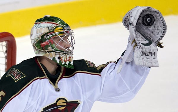 Darcy Kuemper makes a save during the first period against Vancouver.