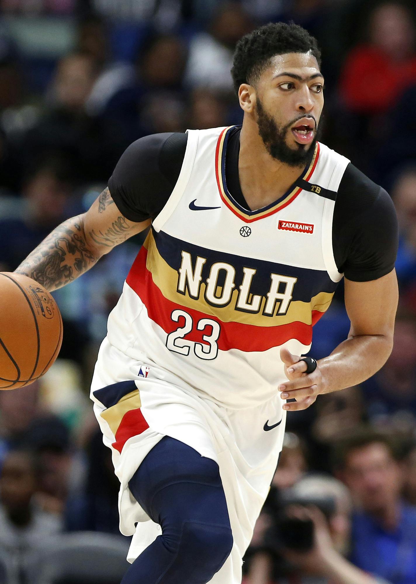 FILE - In this March 16, 2019, file photo, New Orleans Pelicans forward Anthony Davis brings the ball up during the first half of the team's NBA basketball game against the Phoenix Suns in New Orleans. Two people familiar with the situation say the Pelicans have agreed to trade Davis to the Los Angeles Lakers for point guard Lonzo Ball, forward Brandon Ingram, shooting guard Josh Hart and three first-round draft choices. The people spoke to The Associated Press on condition of anonymity because